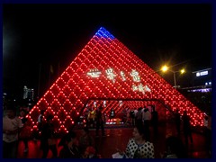 Windows of the World metro station. Inspired by the glass pyramid at the Louvre in Paris. It is illuminated and  changes colours at night.